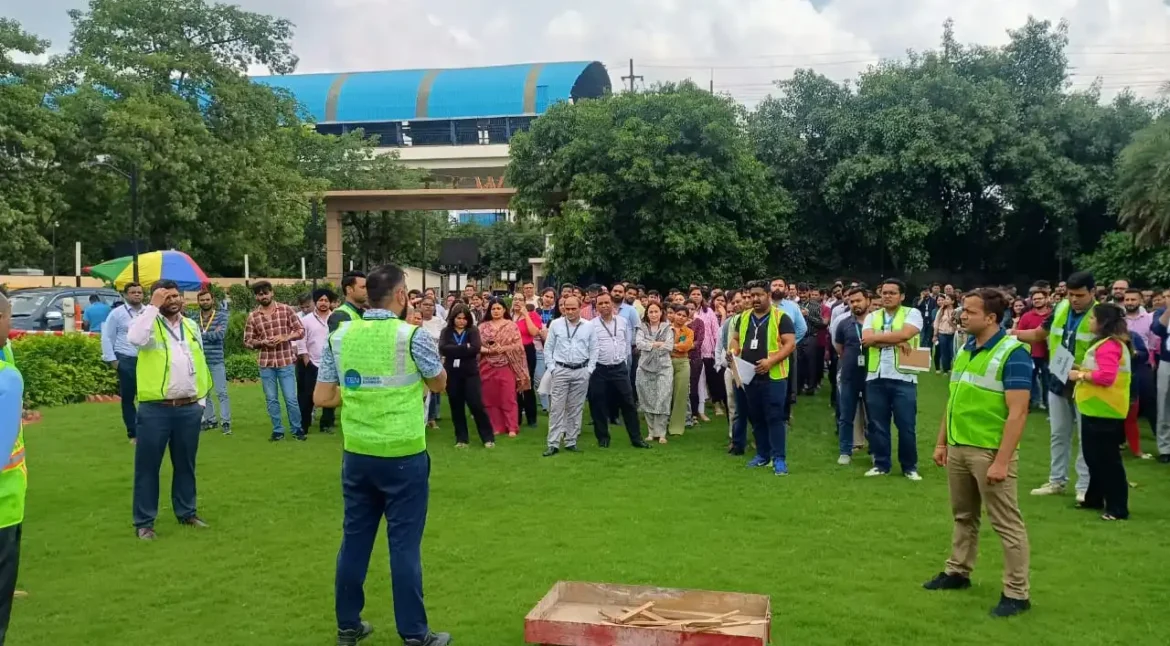 Fire safety training session with practical extinguisher demonstration in an industrial facility